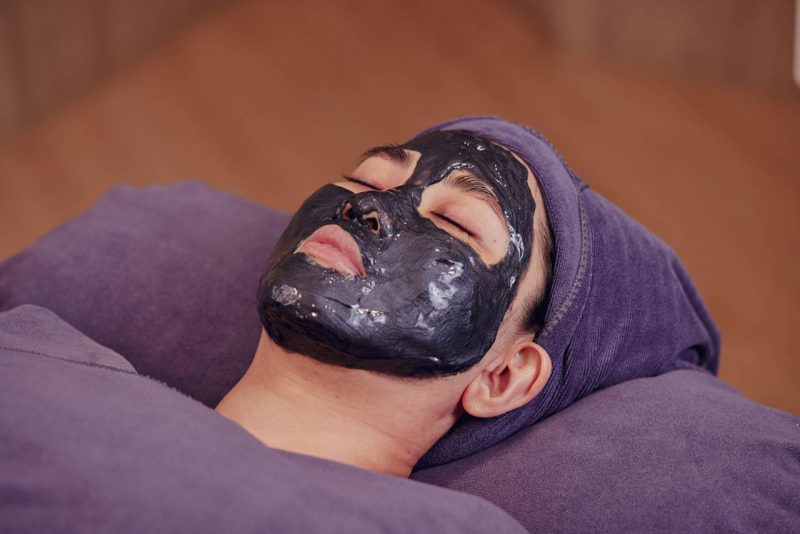 Charcoal mask during an oily skin facial
