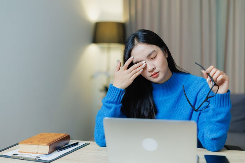 Girl experiencing screen-related eye fatigue.