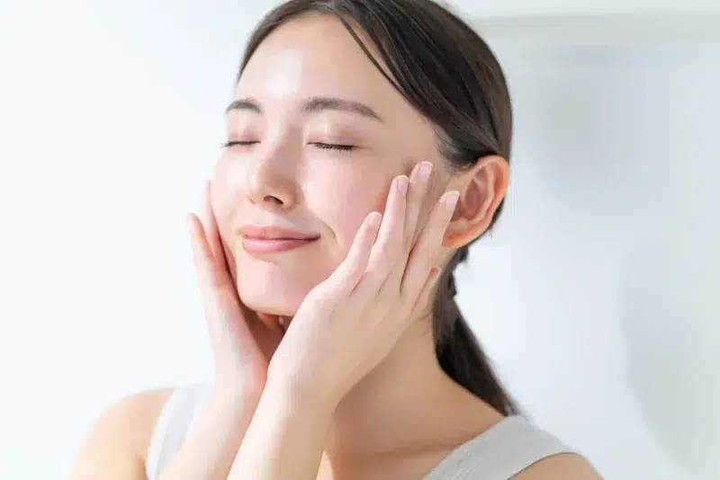 Women with radiant skin after applying serum.