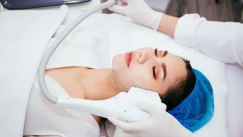 A woman receiving laser treatment at a medical spa